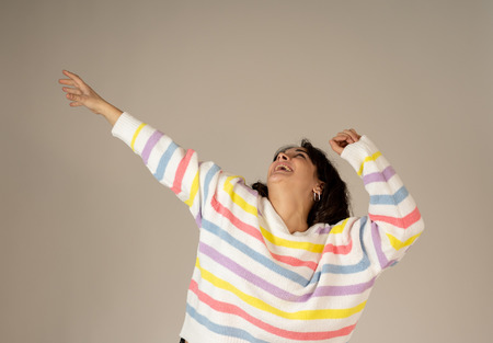 Portrait of shocked young woman wining the lottery or having great success with surprised and happy...