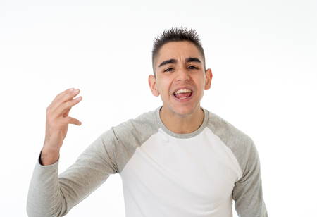 Portrait of angry and upset young man looking furious, aggressive and crazy in People and human emotions, facial expressions, education, violence and bullying concept. Isolated on white background.の写真素材