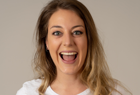 Close up portrait of attractive young caucasian woman with happy face and beautiful smile. Isolated...