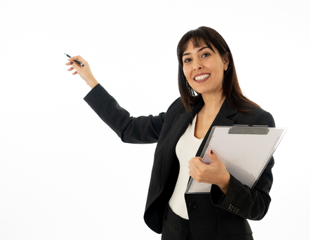 Portrait of young pretty confident businesswoman with folder showing and pointing at copy space as in a conference or Marketing business. In People, education, successful women and corporate concept.の写真素材