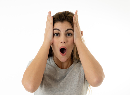 Beautiful young blond woman with happy face pointing and making surprised gestures and looking at...