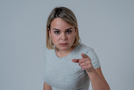 Close up of young attractive caucasian woman with an angry face. Looking mad and crazy shouting and...