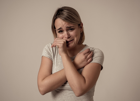 Portrait of young sad depressed woman crying, looking miserable and hopeless. Feeling sorrow, grief and fear. In People, mental health, broken heart, facial expressions and emotions concept.の写真素材