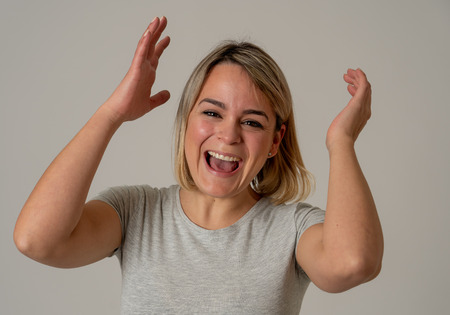 Portrait of beautiful shocked woman winning the lottery or having great success with surprised and...