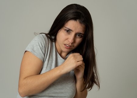 Close up of young woman feeling scared and shocked making fear, anxiety gestures. Looking terrified and desperate. With copy space. People and Human expressions and emotions concept.の写真素材