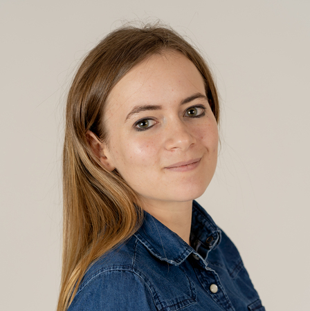 Studio portrait of young beautiful teenager woman with blond hair wearing jean shirt feeling confident, relaxed posing and modeling. Isolated on neutral background. In lifestyle and beauty concept.の写真素材