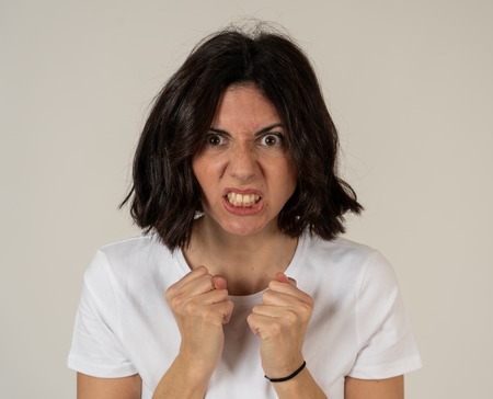 Close up of young frustrated caucasian woman with angry and stressed face. Looking mad and crazy...
