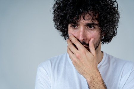 Portrait of young sad man, worried and concerned, looking depressed and desperate. Feeling sorrow...