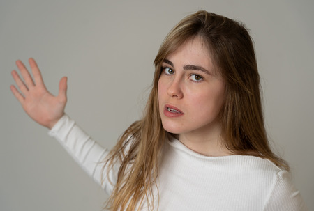 Annoyed irritated young teenager girl looking angry and mad. Feeling frustrated making furious gestures. Close up studio shot Isolated on neutral background. People, Facial expressions and emotions.の写真素材