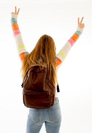 Back view portrait of happy and cheerful teenager girl celebrating vacations, success, getting into university or student lifestyle isolated on white background. In celebration education and success.の写真素材