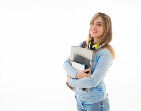 Portrait of beautiful teenager girl with backpack and notepad folder smiling against white background. Young college teen woman happy to start university. in People Education and student lifestyle.の写真素材