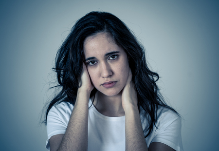 Portrait of young sad latin woman suffering depression looking thoughtful. Feeling emotional pain, sorrow distressed. Isolated with copy space. Human expressions Emotions and women Mental health.の写真素材