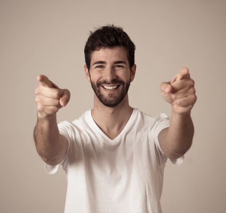Portrait of young happy and excited man winning the lottery celebrating goal or having great success with proud face. In People success and Facial Expression and positive Human Emotions.の写真素材