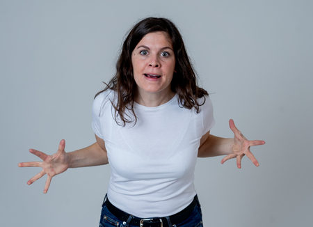 Facial expressions and emotions. Portrait of Young attractive caucasian woman with an angry face. Looking mad and crazy shouting and making furious gestures. Isolated on neutral background.の写真素材