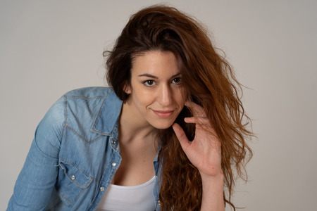 Portrait of young beautiful caucasian woman with red hair attractive face and beautiful smile posing in jeans shirt. In People, Beauty, positive human expression and marketing friendly image.の写真素材