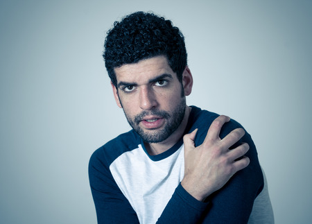 Portrait of young man in shock with scared face with frightened gestures and looking at something scaring. Human emotions feelings and facial expression. Isolated on neutral background.の写真素材