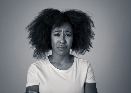 Portrait of african american woman in pain with sad and exhausted face looking concerned, worried...