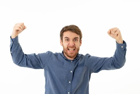 Portrait of young happy and excited man winning the lottery celebrating goal or having great success...