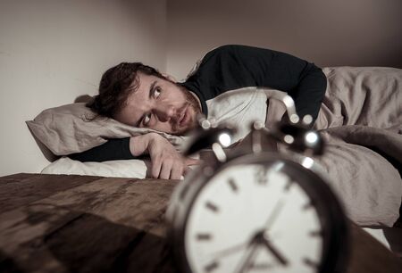 Mental health, Insomnia and sleeping disorders. Frustrated and hopeless sleepless man looking in...