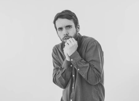 Portrait of young man in shock with scared face paralysed with fear and frightened face looking at something scaring. Human emotions feelings and facial expression. Isolated on neutral background.の写真素材