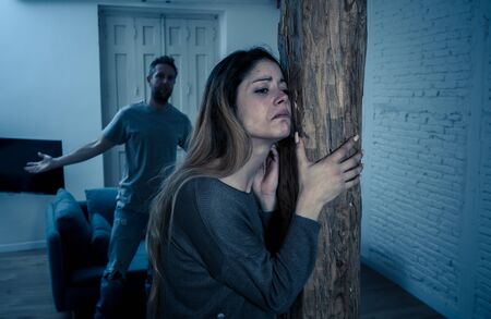 Social issues Domestic violence concept. Alcoholic and abuser partner beating and threatening his terrified wife. Violent man physically abusing scared girlfriend terrified of aggression and abuse.の写真素材