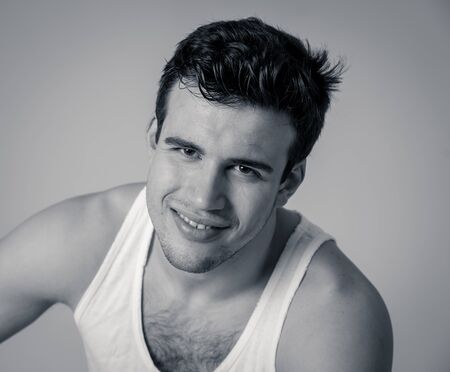 Portrait of young attractive manly latin man in his 20s looking sexy posing against neutral...