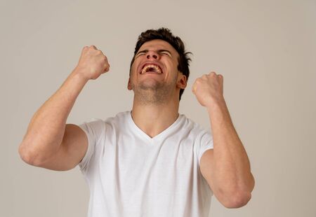 Portrait of handsome shocked young man hearing good news, winning or having great success with surprised happy face. Making cheerful gestures. Facial Expression, Human Emotions and celebration.の写真素材