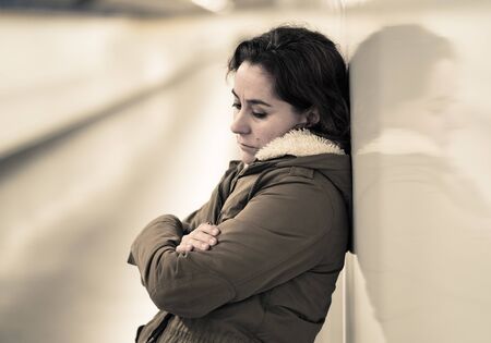 Hopeless and exhausted woman suffering depression and anxiety in subway tunnel in Work-life balance issues Negative body image Financial troubles and Stressful life events Mental health and loos of loved one.の写真素材