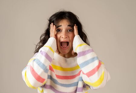 Portrait of shocked young woman wining the lottery or having great success with surprised and happy Face gestures. Facial Expression, Human Emotions and celebration. Isolated on neutral background.の写真素材