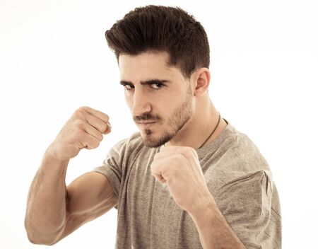 Close up portrait of young violent man with angry face looking furious and crazy showing fits and pointing finger at the camera. Human facial expressions, emotions and behavioral problems concept.の写真素材
