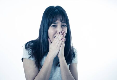 Close up of young woman feeling scared and shocked making fear, anxiety gestures. Looking terrified and desperate. People and Human expressions and emotions concept. Isolated on neutral background.の写真素材
