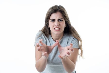 Close up of young attractive caucasian woman with an angry face. Looking mad and crazy shouting and...