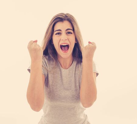 Portrait of beautiful shocked woman winning the lottery or having great success with surprised and...