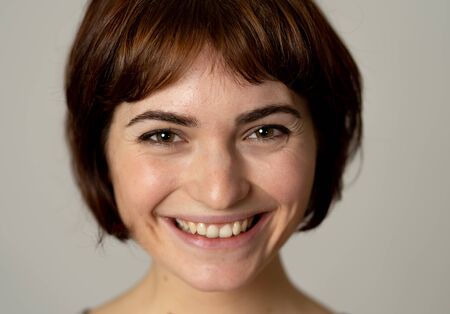 Close up portrait of attractive young pretty caucasian woman with happy face and beautiful smile. Isolated on white. In People, positive human facial expressions and emotions concept.の写真素材