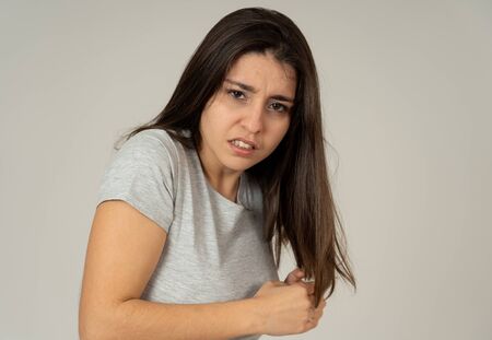 Close up of young woman feeling scared and shocked making fear, anxiety gestures. Looking terrified and desperate. With copy space. People and Human expressions and emotions concept.の写真素材