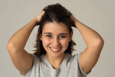 Close up portrait of pretty young latin woman with happy face and beautiful smile. Messing with her...