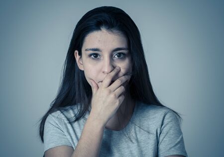 Close up of young sad woman, serious and concerned, looking worried and thoughtful feeling sorrow...