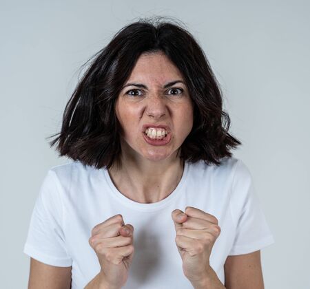 Close up of young frustrated caucasian woman with angry and stressed face. Looking mad and crazy...