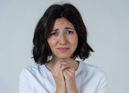 Portrait of sad woman worried and concerned, looking desperate and disgusted. Staring with stern look. isolated neutral background. Depression and negative emotions and people expressions concept.の写真素材