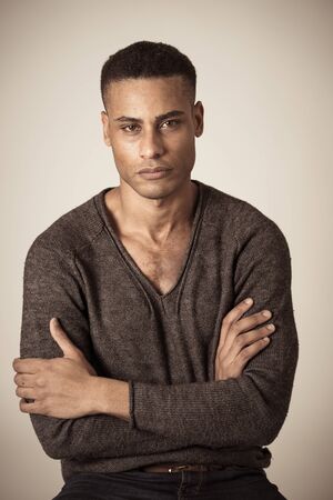 Portrait of young attractive stylish african american man model posing in casual clothes against...