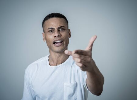 Close up portrait of a handsome african american man with a surprised and shocked face. Attractive...