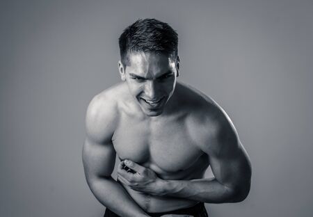 Strong sexy handsome Athletic man laughing and feeling good after workout. Studio shot of Mixed race latin fitness model posing for sports, beauty or fashion advertisement. In happy healthy lifestyle.の写真素材