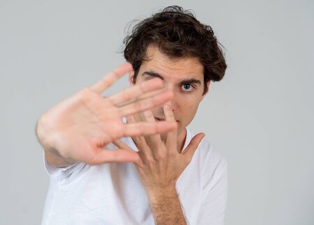 Portrait of Handsome latin young man in shock with a scared expression on his face making frightened...
