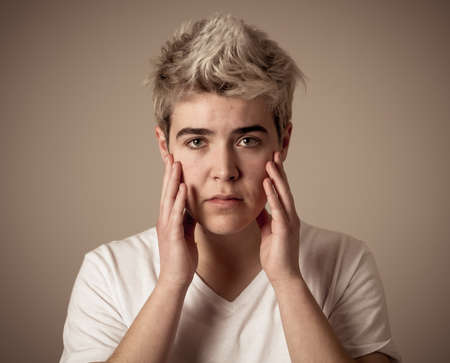 Young sad trans teenager boy suffering from depression feeling sad and desperate. Depressed...