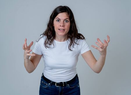 Facial expressions and emotions. Portrait of Young attractive caucasian woman with an angry face....