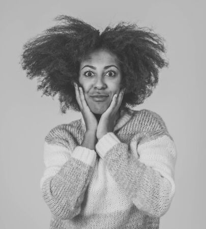 Close up portrait of beautiful young african american woman posing happy making funny faces looking at the camera having fun. In People humor and Positive Human facial expressions and emotions.の写真素材