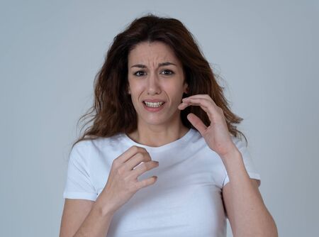 Portrait of young woman feeling scared and shocked making fear, anxiety gestures. Looking terrified and desperate. People and Human expressions, aggression, domestic violence and victim concept.の写真素材