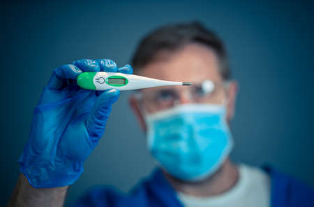 COVID-19 Outbreak visual support. Doctor holding thermometer. Protect yourself and prevent the...