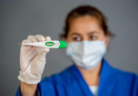 COVID-19 Outbreak visual support. Doctor holding thermometer. Protect yourself and prevent the...