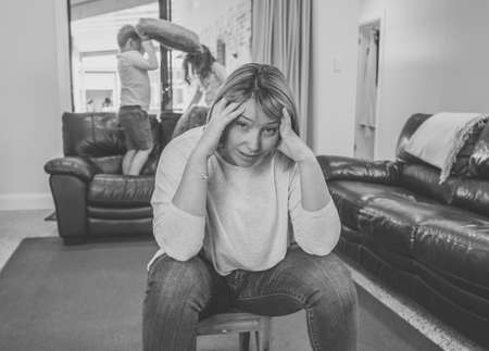 Stressed out parents struggling with having the children at home during Coronavirus self-isolation. Mother and father trying to cope with anxious kids during quarantine. COVID-19 Health crisis impact.の写真素材